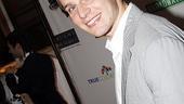 Jonathan Groff autographs the guitar for charity.