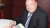 Kevin Chamberlin makes his mark by signing the portrait.