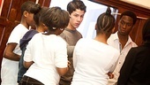 The newly minted director is hard at work with his actors.