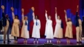 Carolee Carmello as Aimee Semple McPherson and the cast of Scandalous.