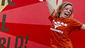 Leah Tott gets airborne with a mural on 6th Street, singing Austin's musical praises.