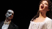 Hugh Panaro looks on as Sierra Boggess kicks off a special post-show performance of the musical’s title song.