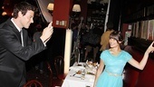 Cory Monteith snaps a shot of Lea Michele posing with the famed Sardi’s portraits of Broadway stars past and present.