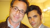 John Stamos gets a little backstage support from his Full House co-star, Bob Saget. 