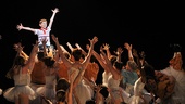 The cast of Billy Elliot raises Tade Biesinger high at the end of the show. 