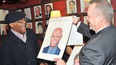 Samuel L. Jackson can't contain his excitement as he is presented with his portrait by Max Klimavicius of Sardi’s.