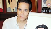 Tony nominee Yul Vazquez poses with his lookalike portrait. 