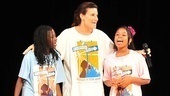 Idina Menzel takes the stage at Columbia University with two Camp BroaderWay kids.