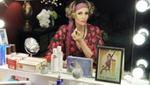 Fresh off the Palace Theatre stage, Emmy winner Jane Lynch sits at her dressing room vanity in full Hannigan costume. Notice the souvenir playbill from Lynch’s opening night. 
