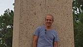 Mark takes a break to lean against a monument in Hermann Park.
