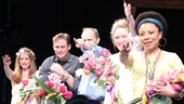 The cast of Vanya cheers as Sigourney Weaver delivers flowers to Christopher Durang in the audience.